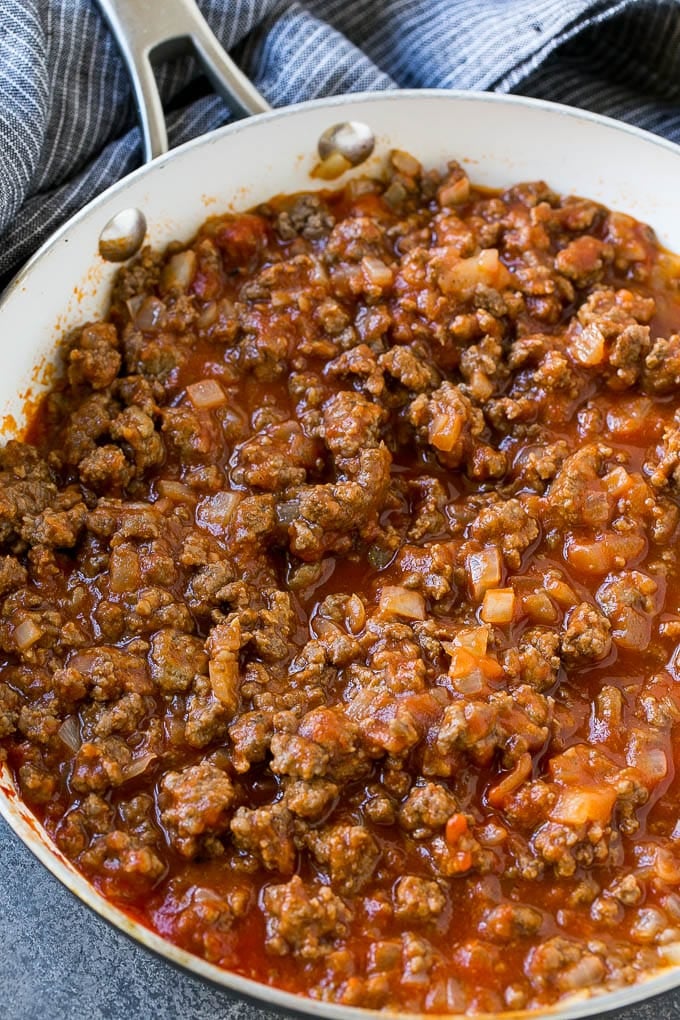 Seasoned ground beef and tomato sauce in a skillet.
