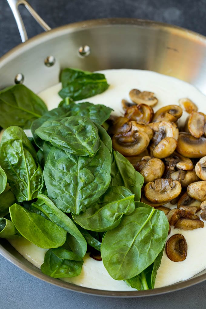 Cream sauce with spinach and mushrooms in it.