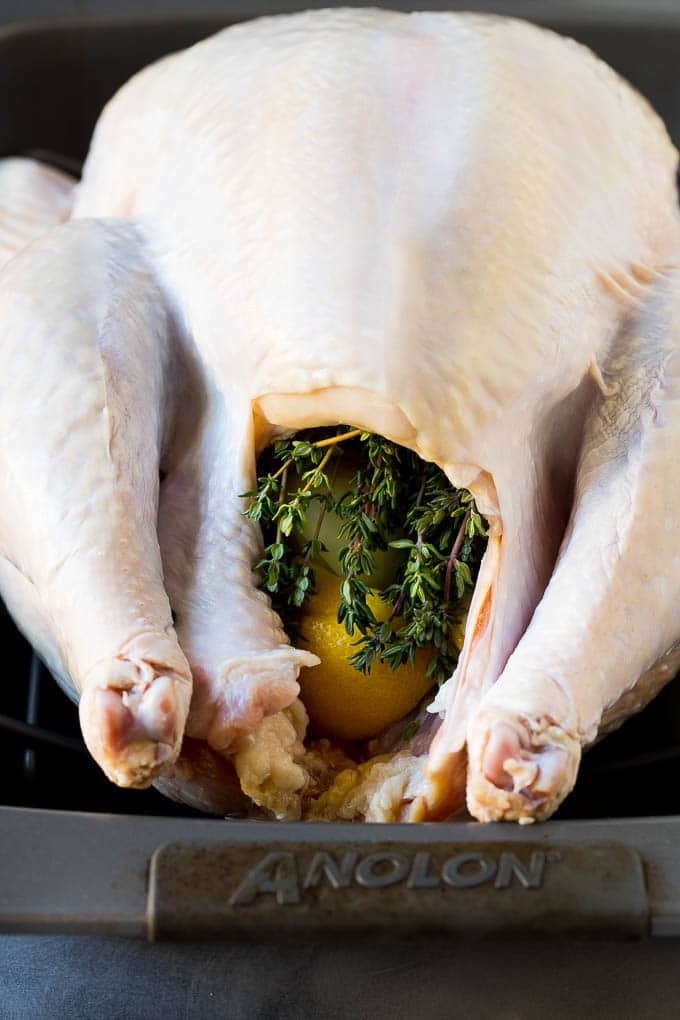 A turkey with the cavity stuffed with lemon and herbs.