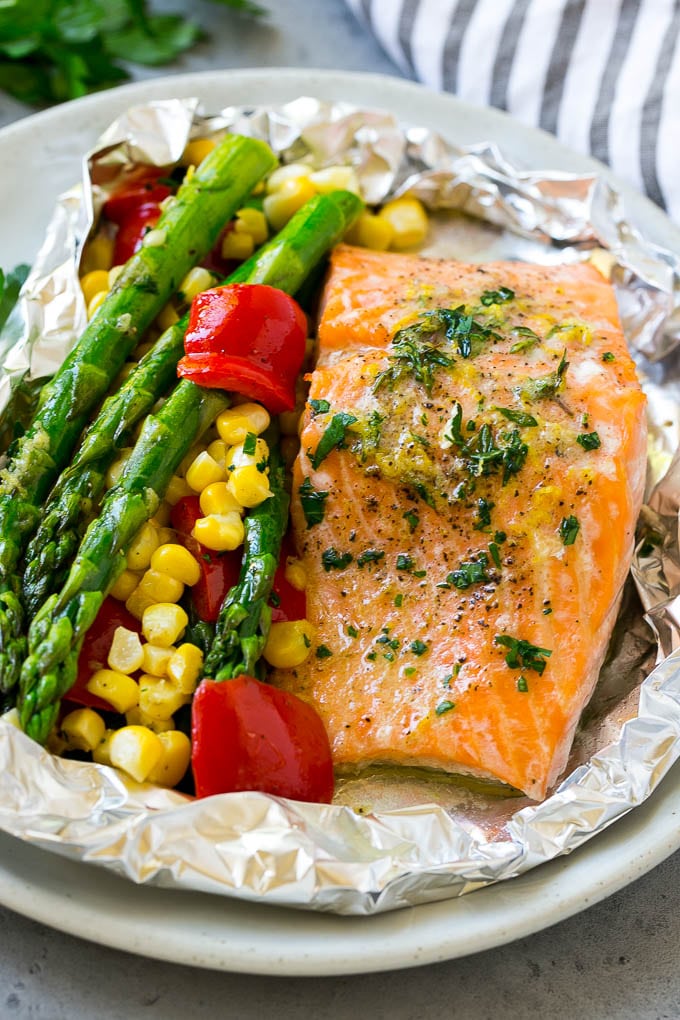 Salmon foil packets that can be baked or grilled with seasoned salmon and fresh vegetables.